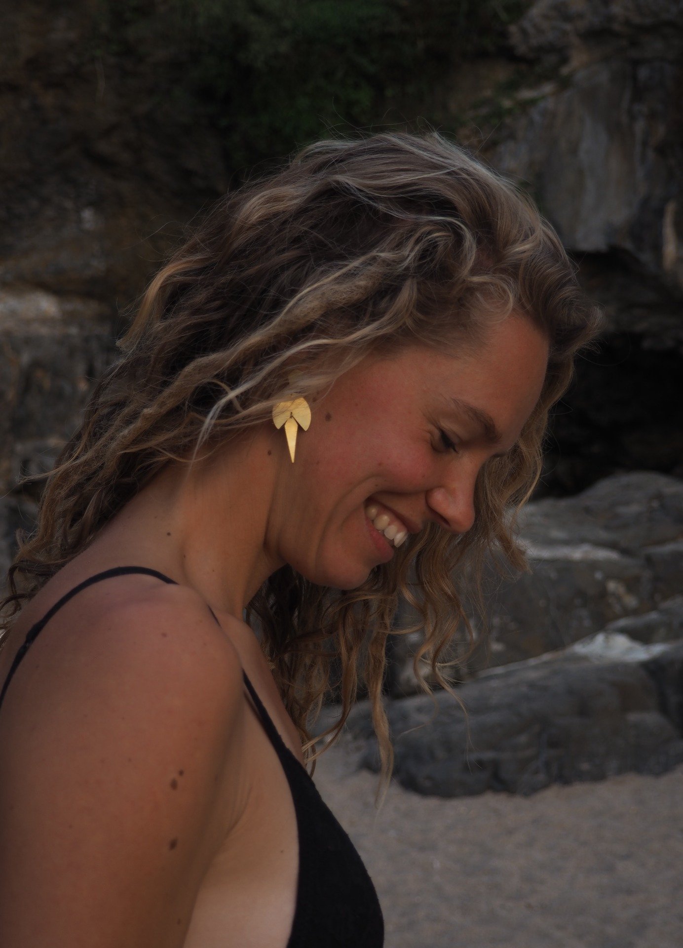 blonde girl wearing sustenuto bohemian brass dangle earrings