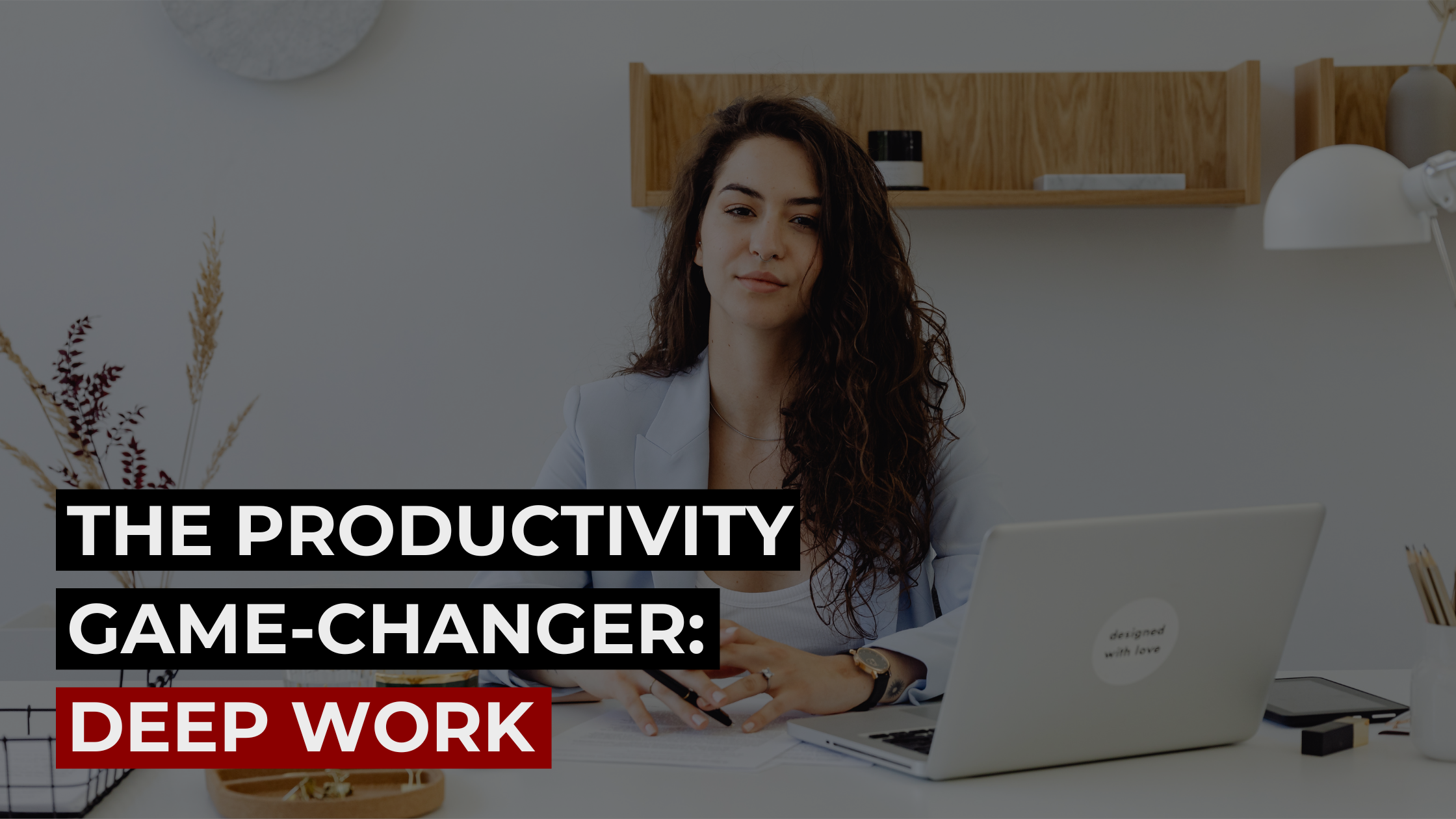 Female entrepreneur working on a laptop at desk, promoting deep work productivity strategy