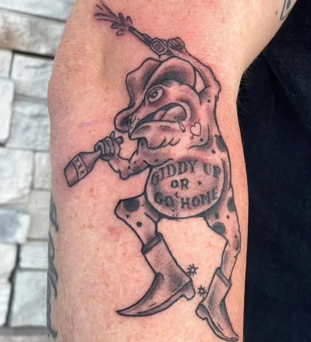 black-grey-cowboy-frog-forearm-tattoo-treasure-island-fl.jpeg