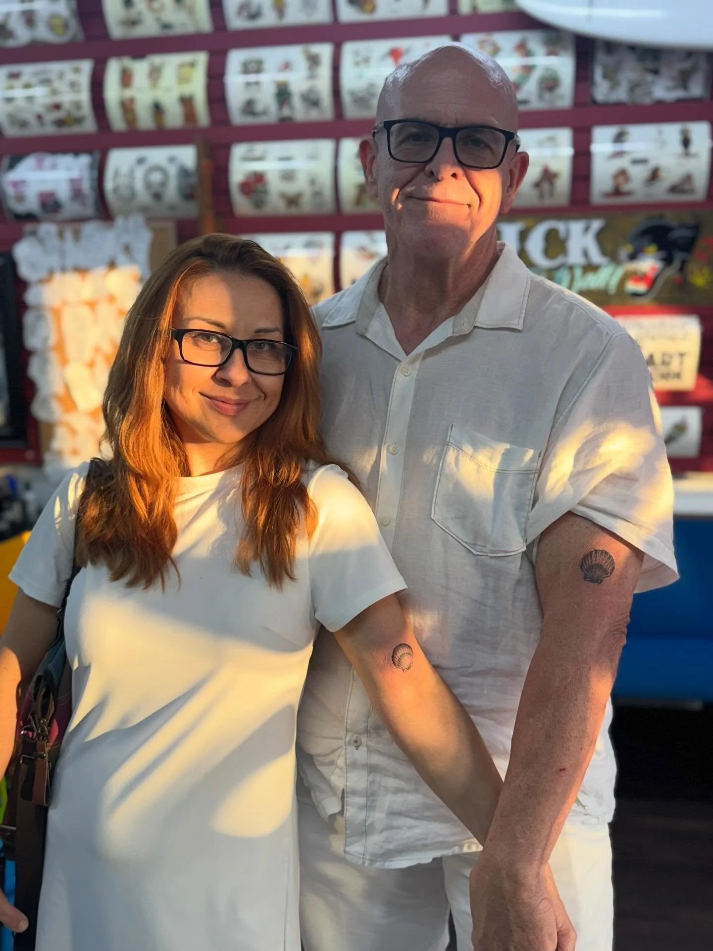 This couple is radiating with their matching beach tattoos! ☀️🐚🌊 walk ins welcome noon to 8pm every day.