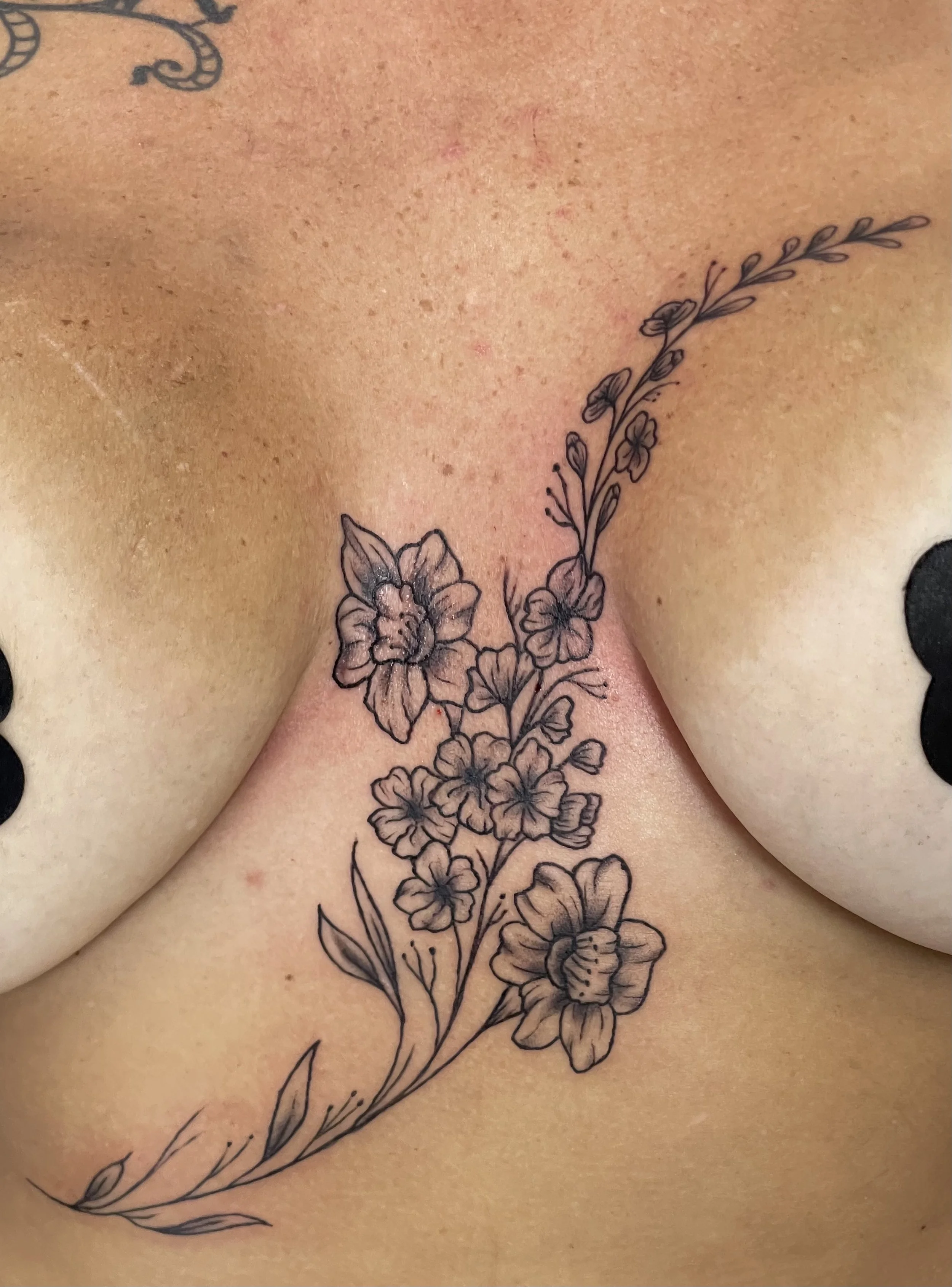 black-grey-flowers-chest-tattoo-treasure-island-fl.jpeg