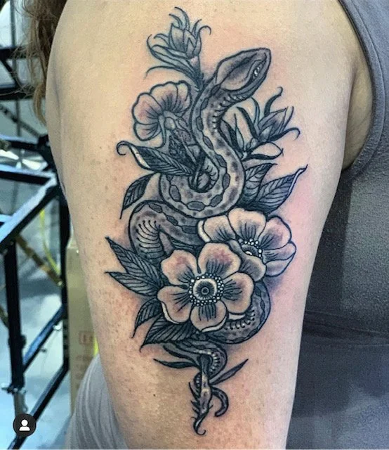 black-grey-snake-in-flowers-arm-tattoo-treasure-island-fl.jpg