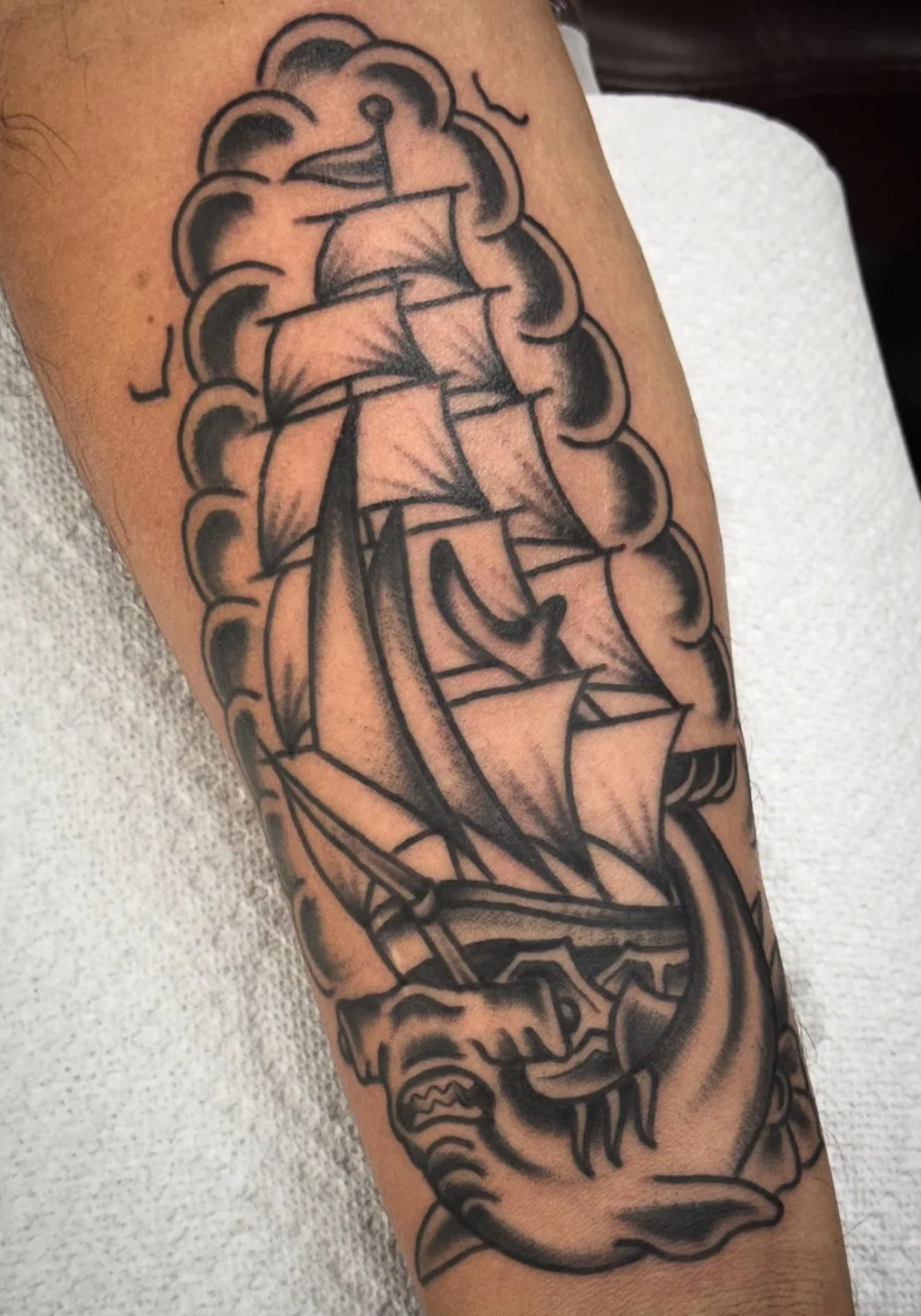 black-grey-boat-with-shark-forearm-tattoo-treasure-island-fl.jpg