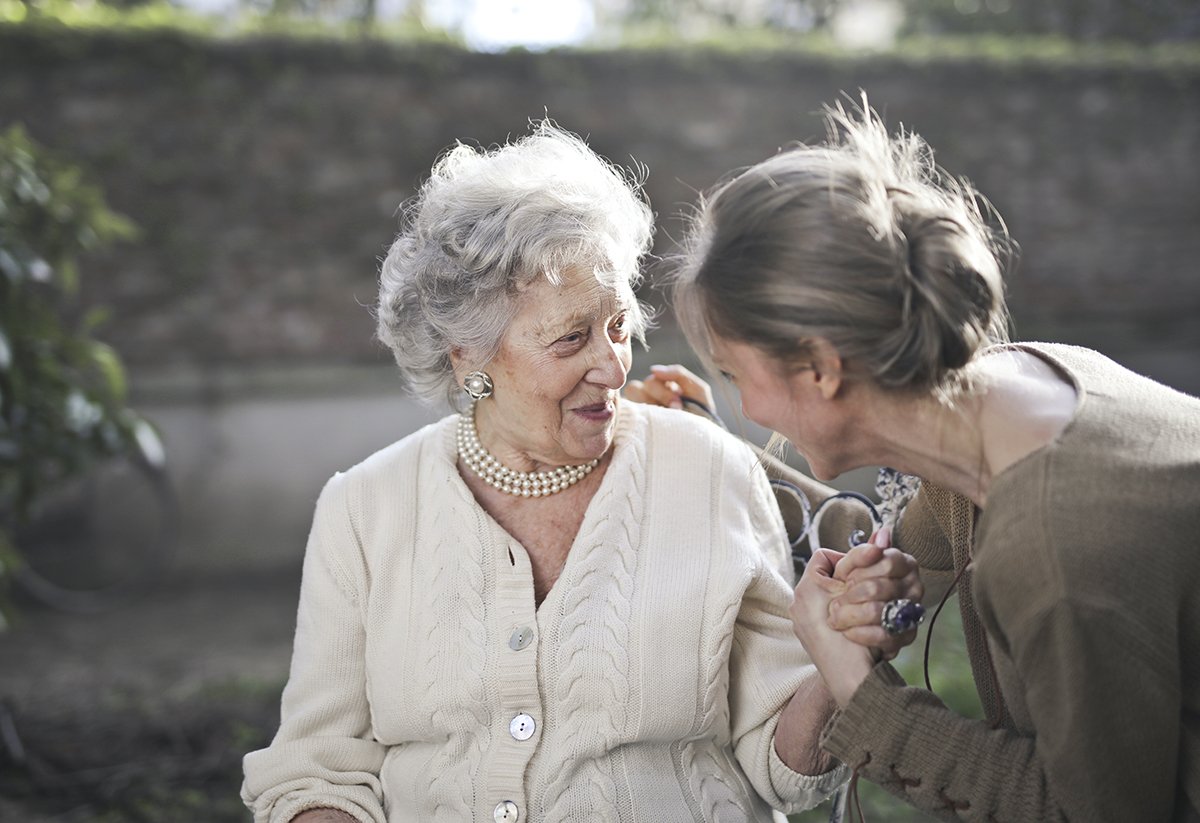 woman helping a senior woman