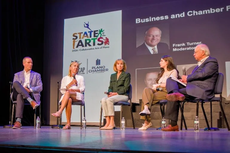 Panel discussion at the State of the Arts 2026 event, featuring five individuals seated on stage in front of a large screen displaying event logos and a moderator's photo.