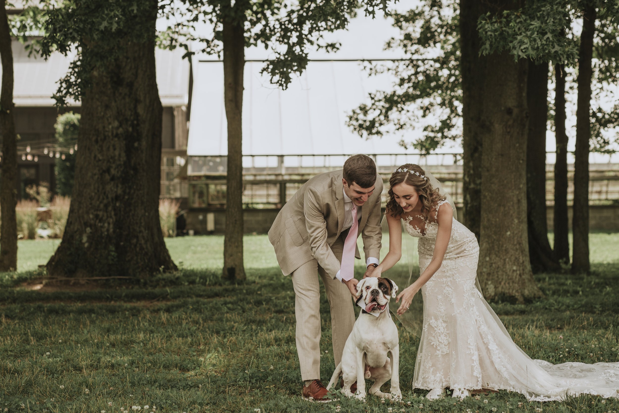 With beaming smiles, the couple lovingly embraced their joyful boxer dog, creating a heartwarming family portrait that exuded love and happiness. The picturesque scene captured the essence of their unbreakable bond, forever immortalizing their cheris
