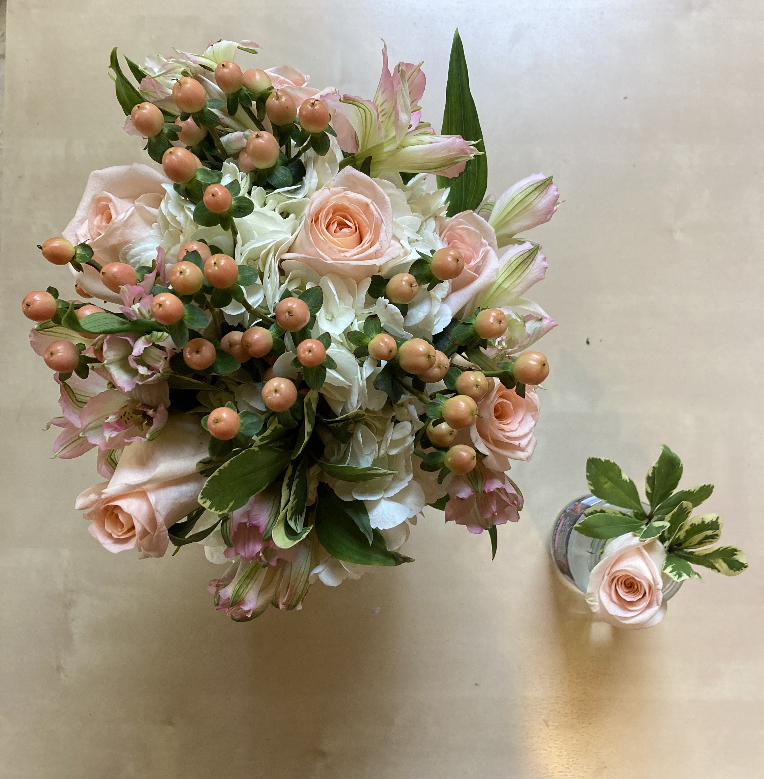 A wedding bouquet and boutonniere for a small wedding during the Covid pandemic. The couple said they wanted pink.