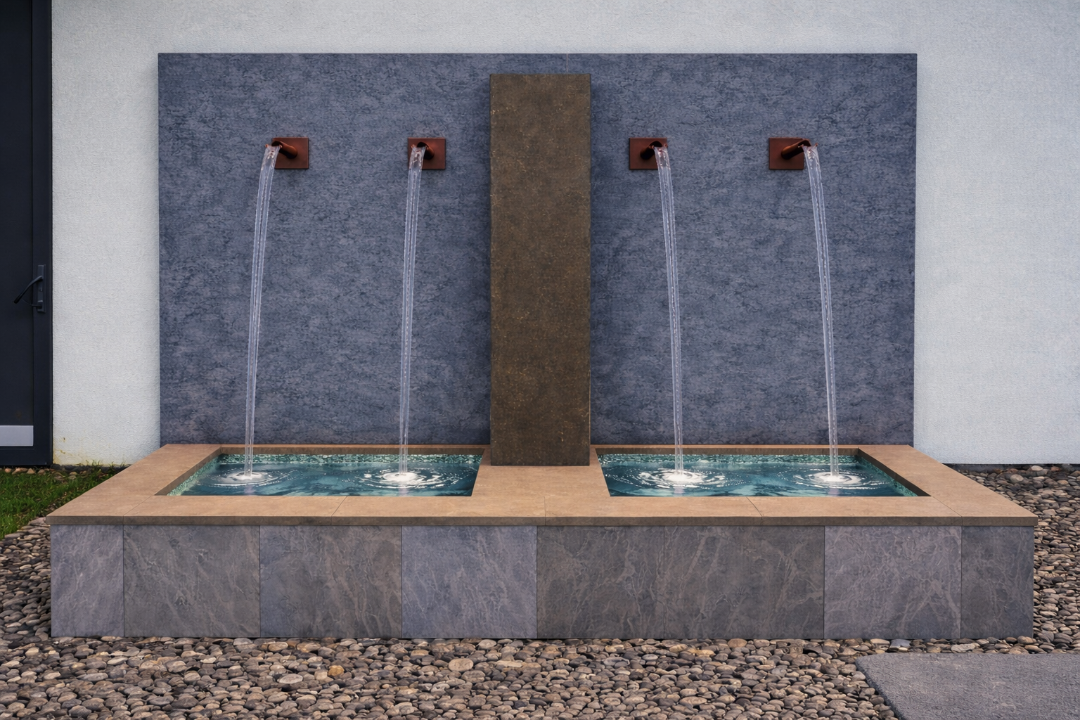 Outdoor water fountain with three water spouts flowing into two basins, mounted on a blue gray tiled wall with a central brown stone pillar.