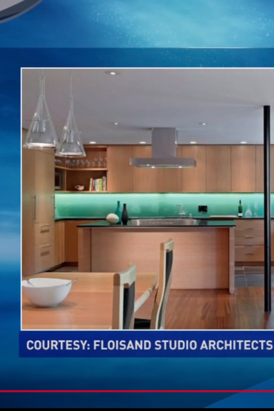 Modern kitchen with wooden cabinets, a green backsplash, a dining table, and pendant lights.