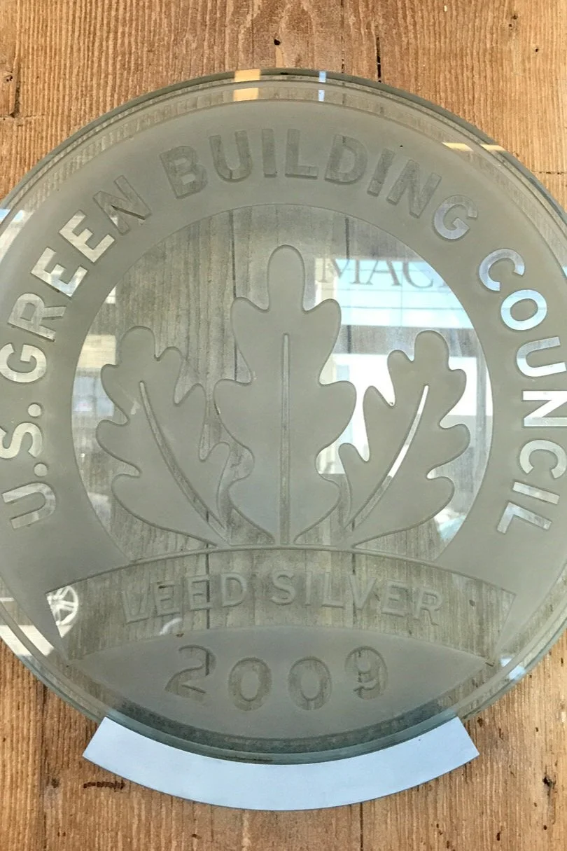 LEED Silver 2009 plaque from U.S. Green Building Council on wood background