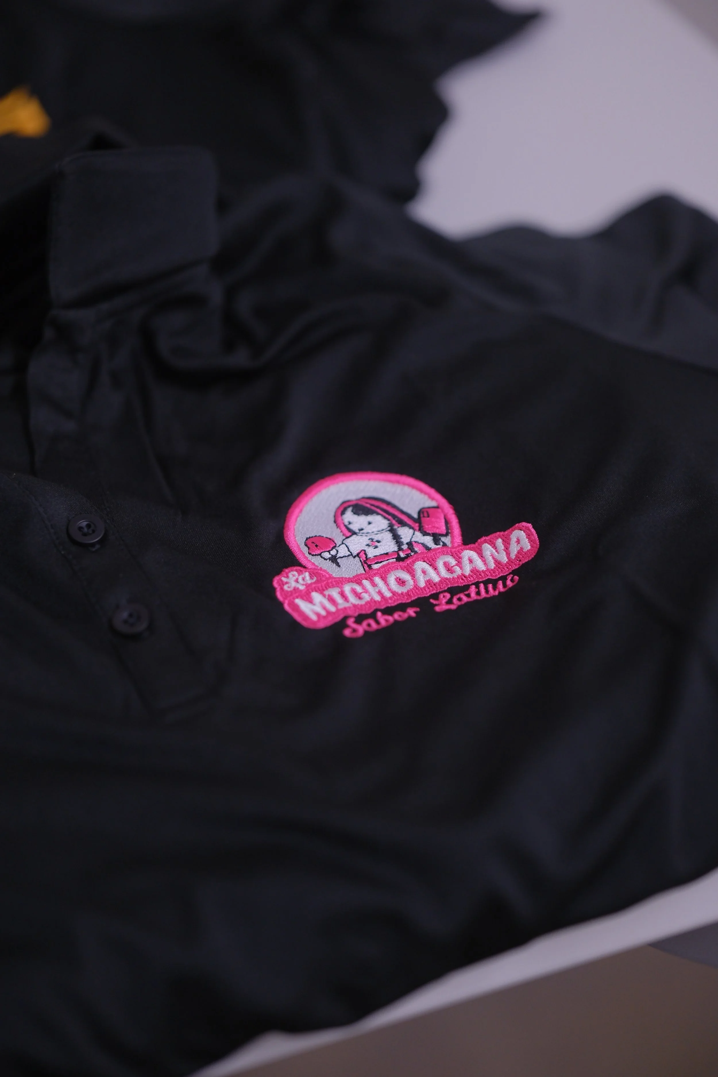 Custom Embroidered Ladies' Polos. LST550 in Black with Custom Pink Company Logo. 