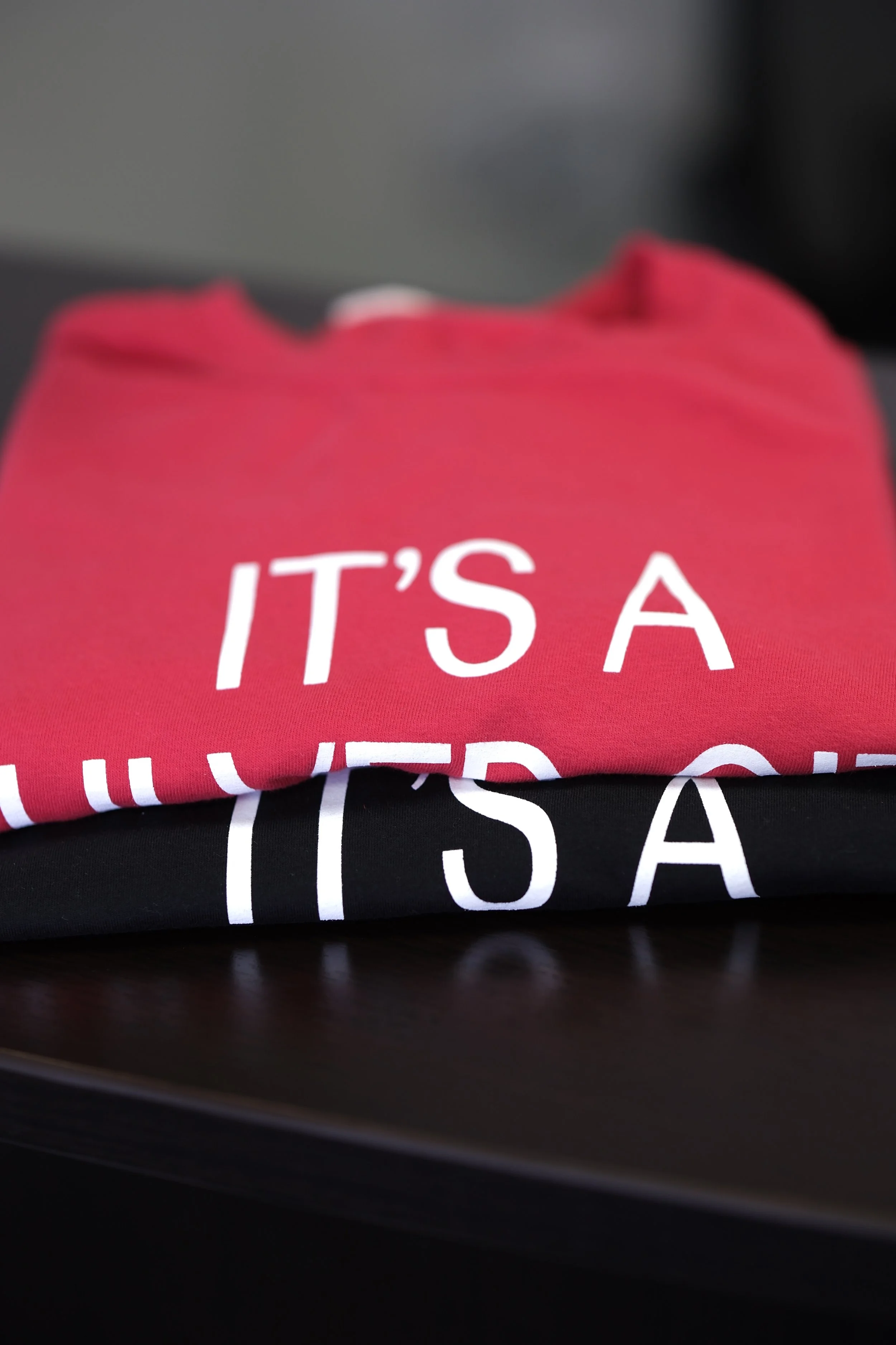 Custom screen printed Bella+Canvas t-shirts with white print. BC3001 red and black screen printed at Meloprint in Riverside, CA. 