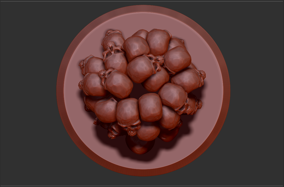 A top view of a round white plate filled with brown, squishy-looking objects that resemble a cluster of grapes or similar fruit, set against a dark background.