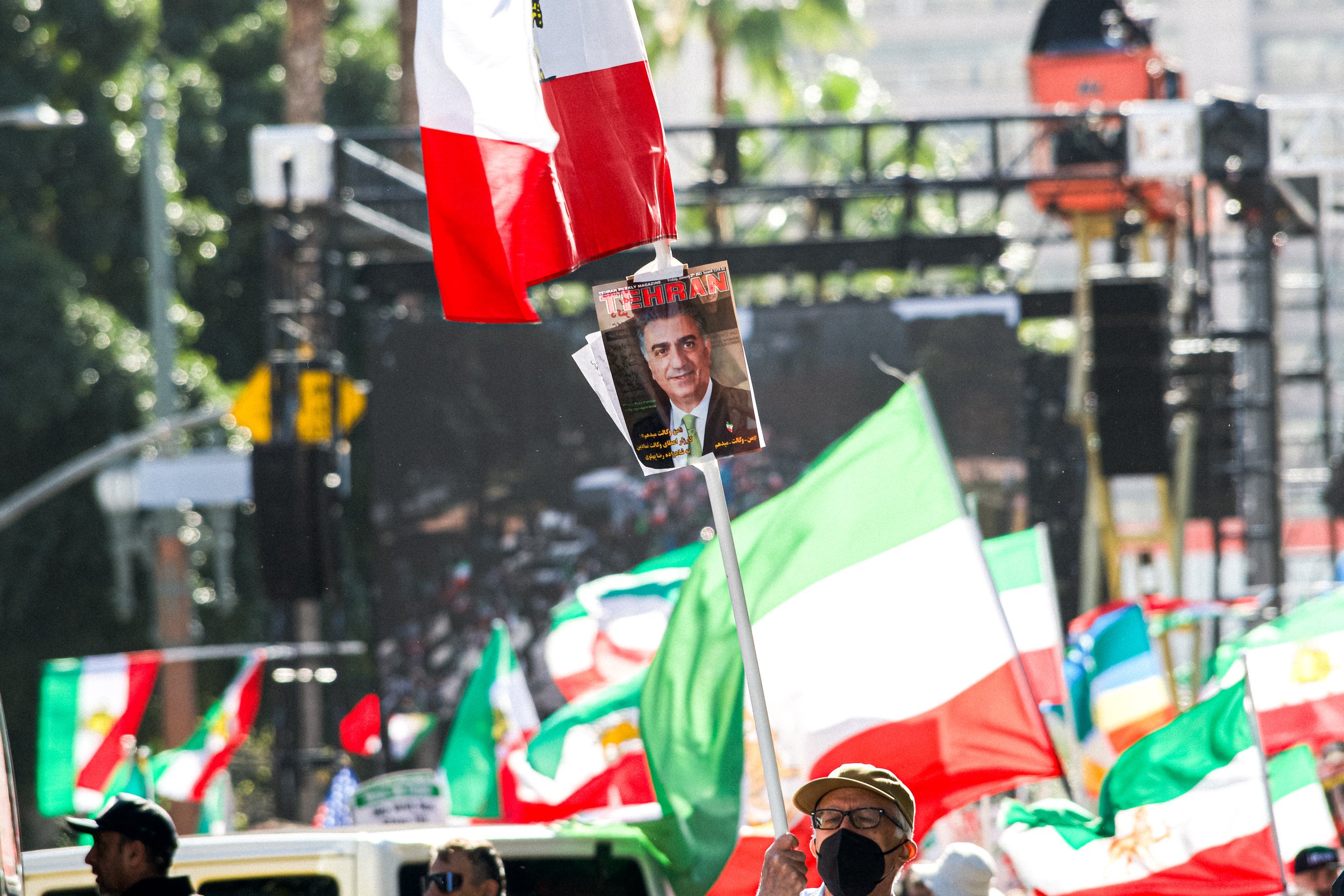 DEATH OF MAHSA AMINI: Man holds sign in support of Prince Reza Pahlavi at Mahsa Amini protest. Feb. 11, 2023.