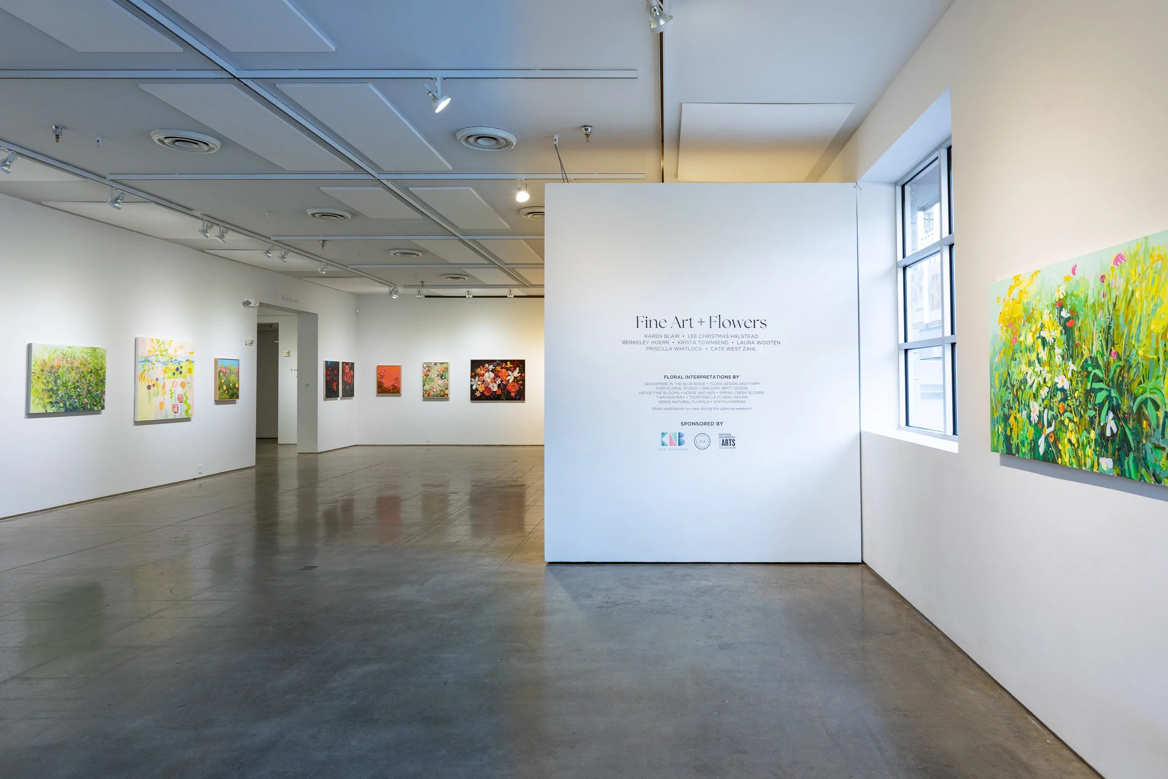 show title sign "Fine Art + Flowers" and paintings of flowers hanging on a gallery wall