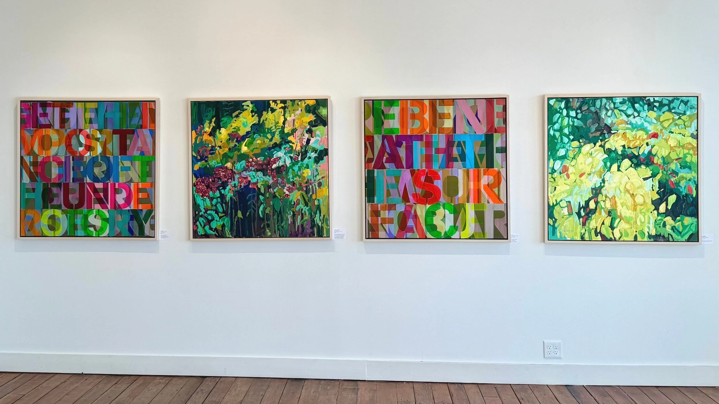 4 paintings hanging on a gallery wall