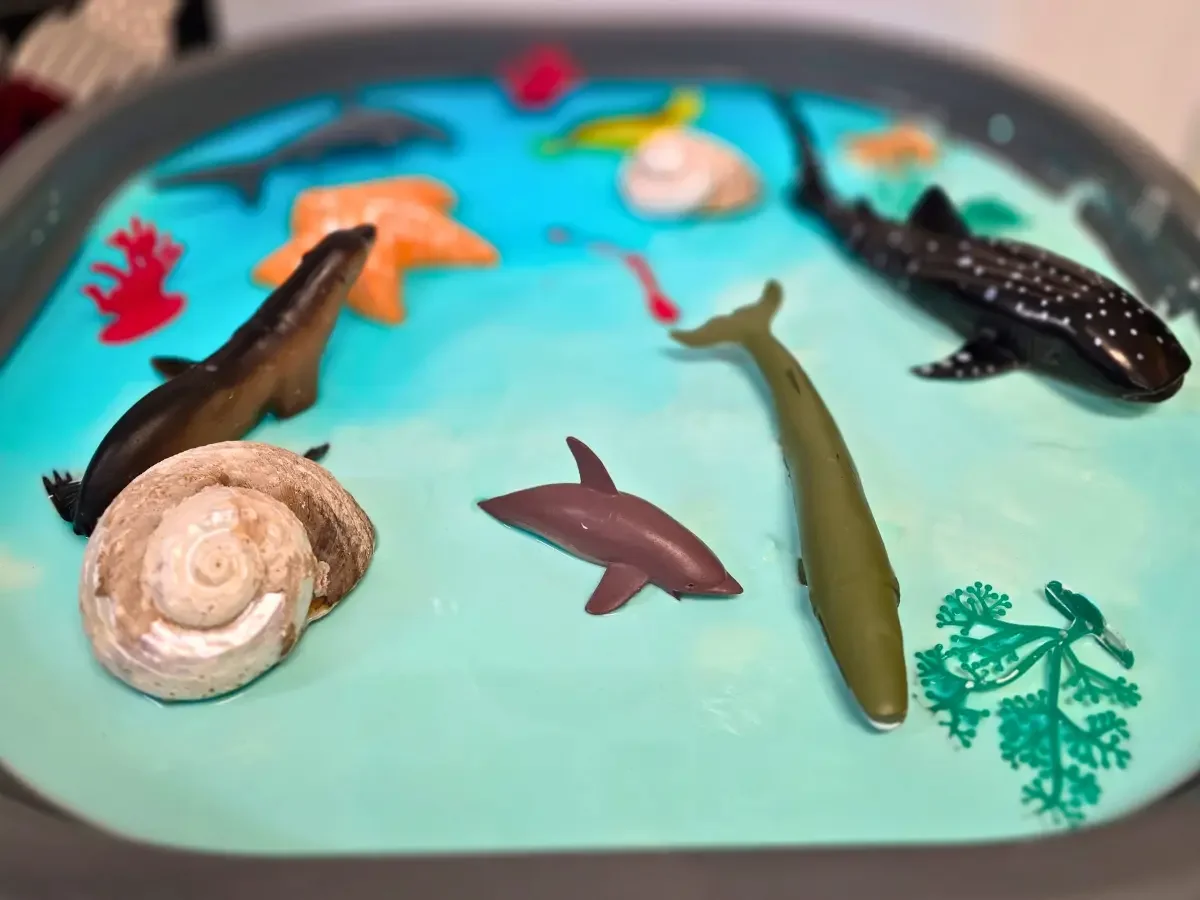 Sensory play tray with ocean animal figurines