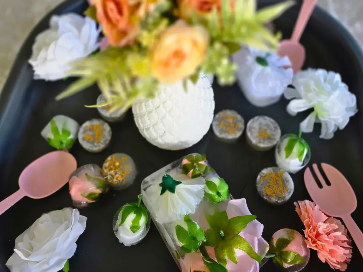 Beautiful sensory play tray with a vase of flowers, scoops, fizz, and flowers frozen in ice