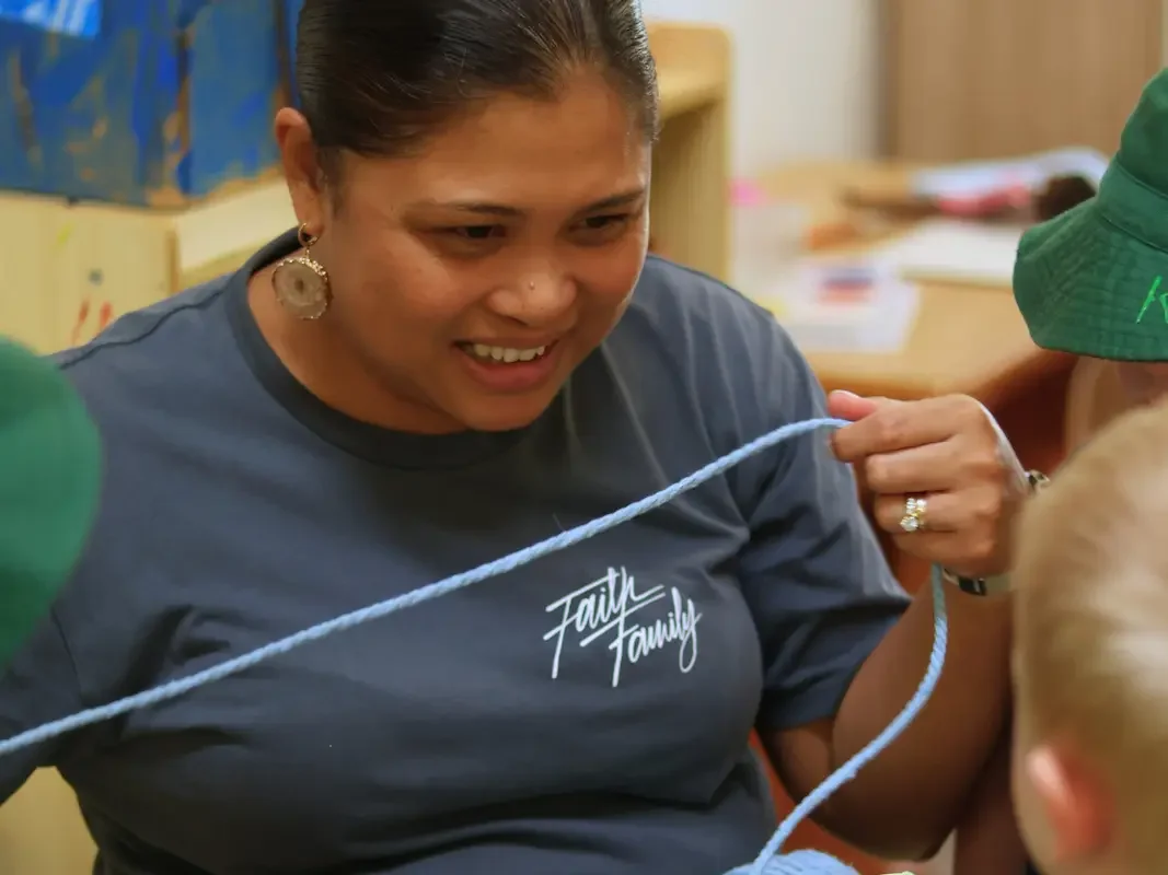 Educator helping children with craft activities