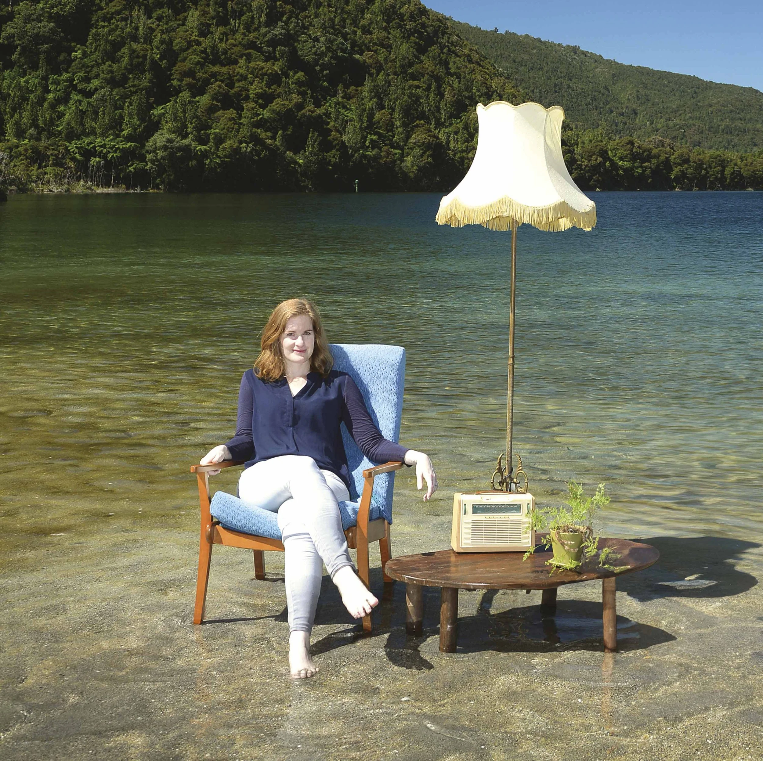 Sarah Lane on chair that's in the lake