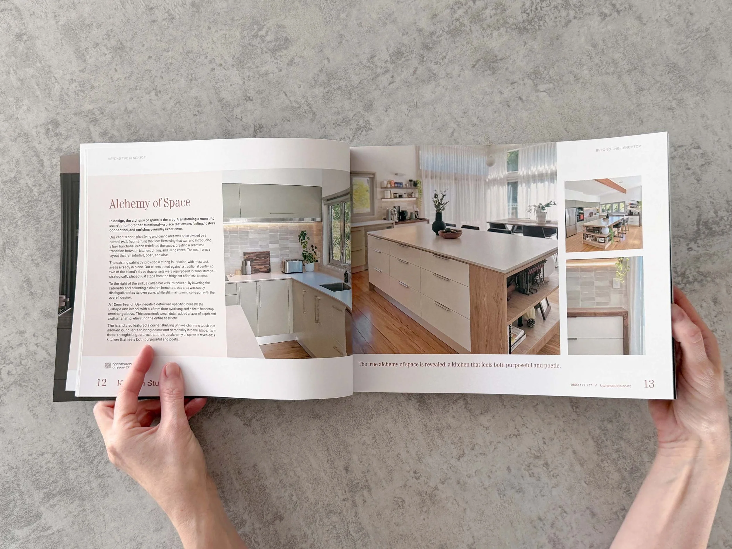 Open magazine showing interior design inspiration, including a kitchen with an island, a dining area with large windows and white curtains, and a living space with shelving and decoration.