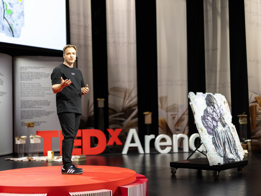 René Konings. Speaker on stage, TEDxArendal 2025.