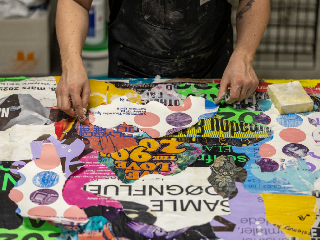 René Konings constructing a homemade canvas from layered posters