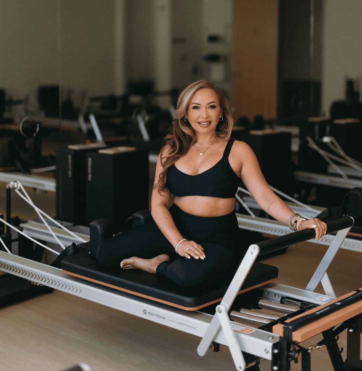 Jenise, Pilates instructor, demonstrating a reformer exercise