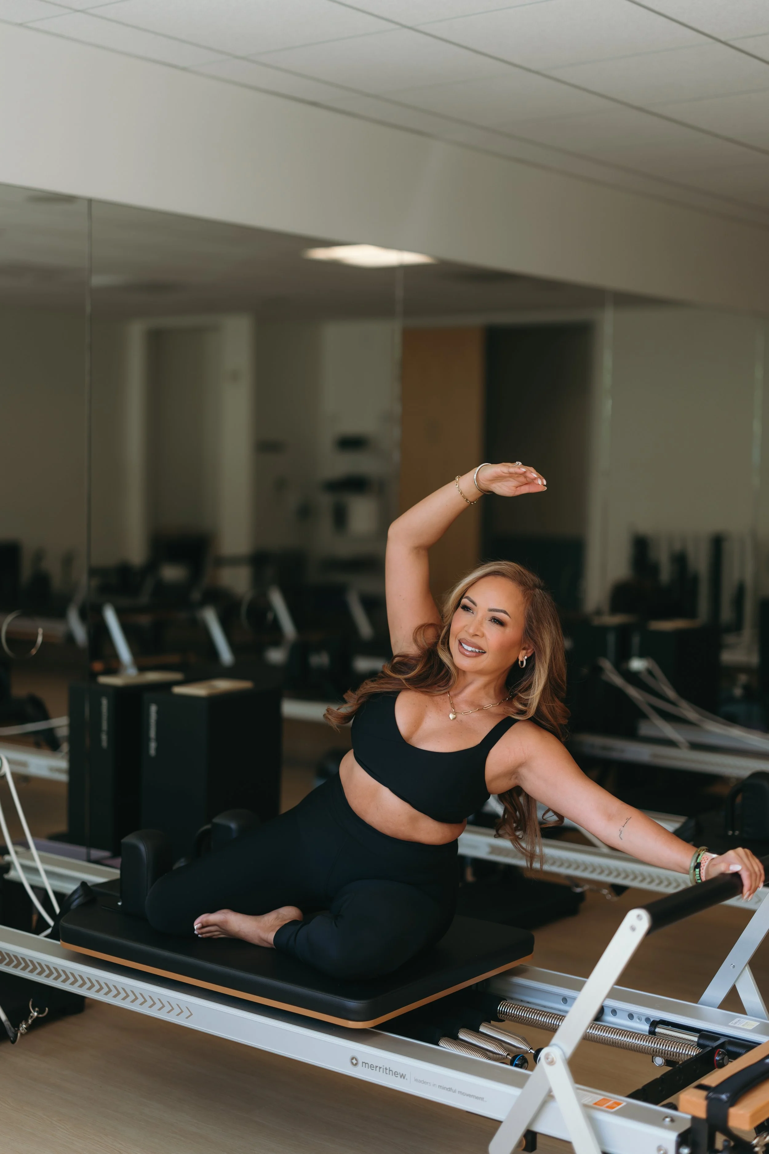 Jenise, Pilates instructor, demonstrating a reformer exercise 2