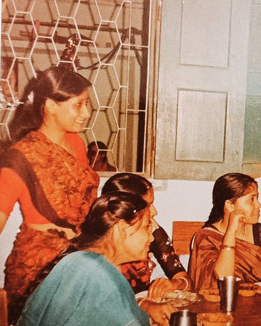 Jalpaiguri, India. 1989.

Maa. 

Newly married, glowing, and hosting neighbors and relatives around a table full of food. The joy on her face says it all. She has always found happiness in feeding people, and I&rsquo;ve grown up watching her turn eve