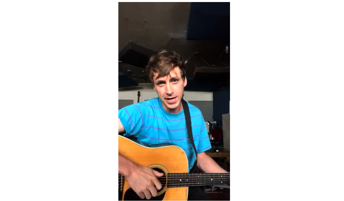 Image of Tyler Kyte performing a song in tribute to Linda Schuyler and Stephen Stohn