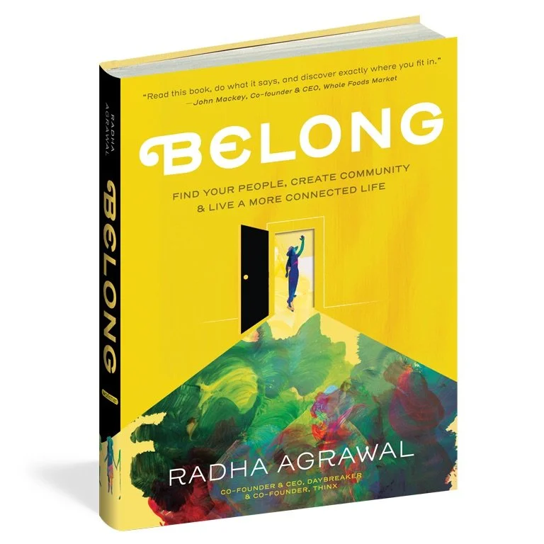 A brightly colored book cover with a yellow background titled "BELONG" by Radha Agrawal, featuring a person walking through an open door onto a vibrant, abstractly painted floor.