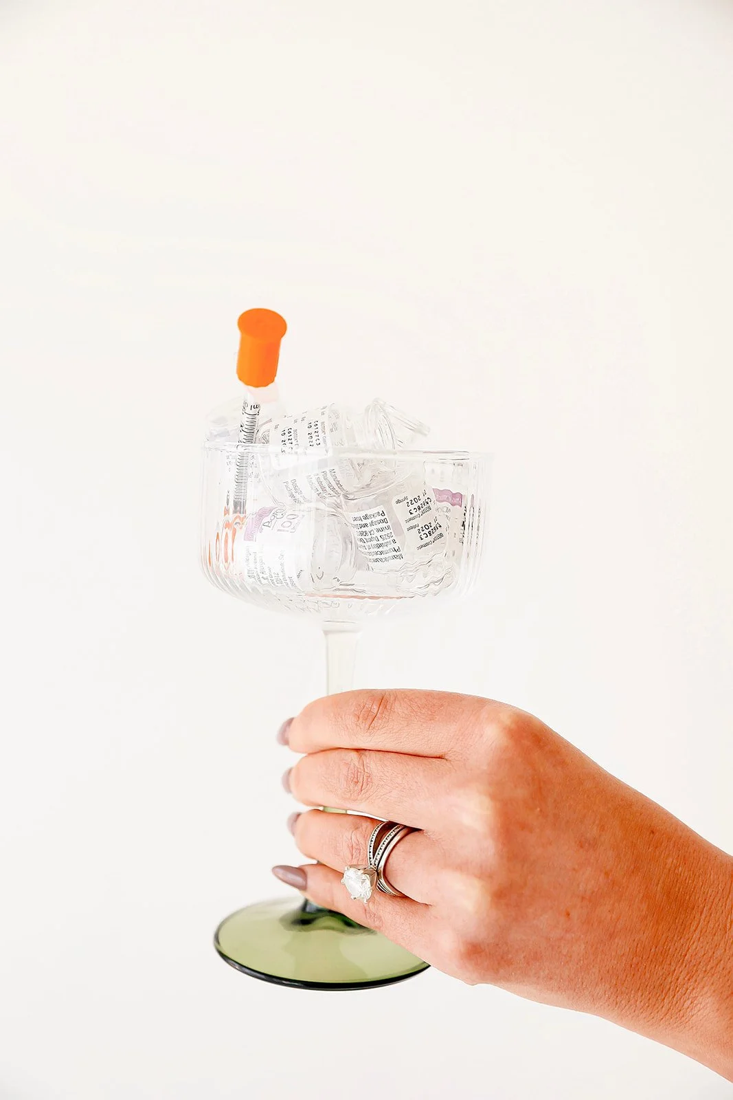 Addison, nurse injector at Meadow Aesthetics in Wichita, KS, holding syringes to promote tox treatments.