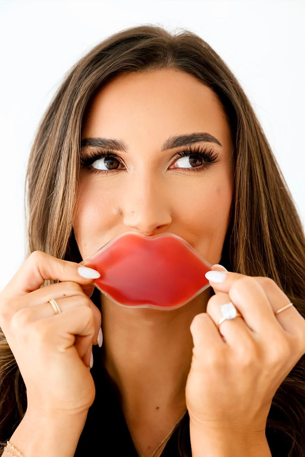 Addison, nurse injector at Meadow Aesthetics in Wichita, KS, holding syringes to promote filler treatments.