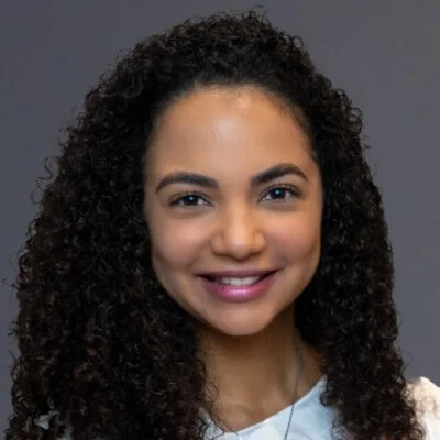 Sameli Mena is a Dominican woman with long curly hair.