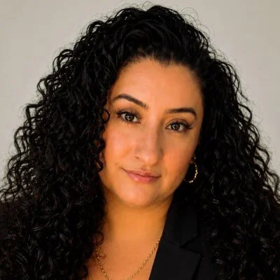 Christina Calzadill is a woman with long dark curly hair