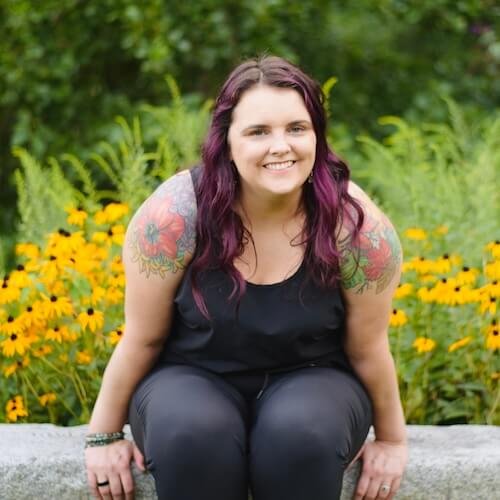 Rosie has purple hair and tattoos of flowers and autumn leaves on each of her shoulders