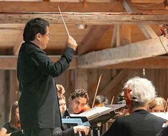 Conductor leading an orchestra during a performance