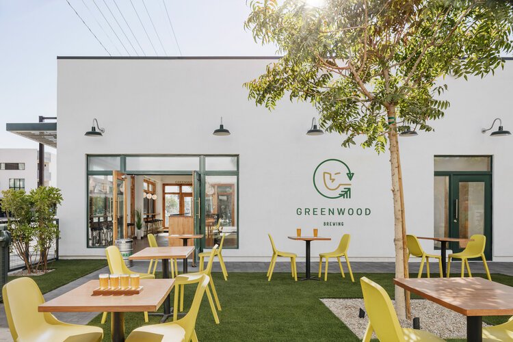  Double doors open to patio space with outdoor tables and patio chairs at Greenwood Brewing in Downtown Phoenix.  
