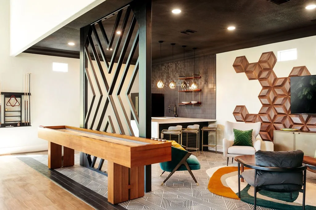 The Franklin Peoria AZ multifamily clubhouse - shuffleboard table with speakeasy lounge and kitchen