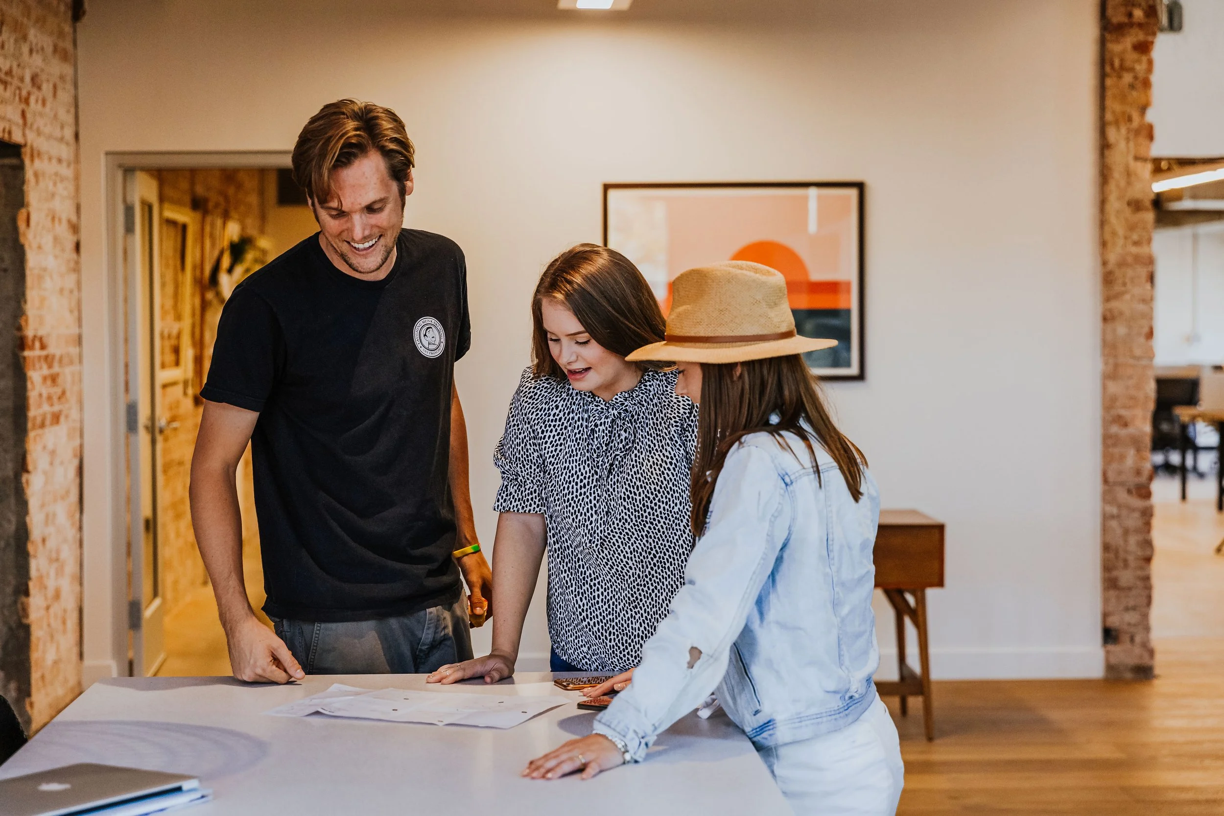 Lemonade Insurance Scottsdale - MCI design team reviewing plans in historic church entry adaptive reuse office interior