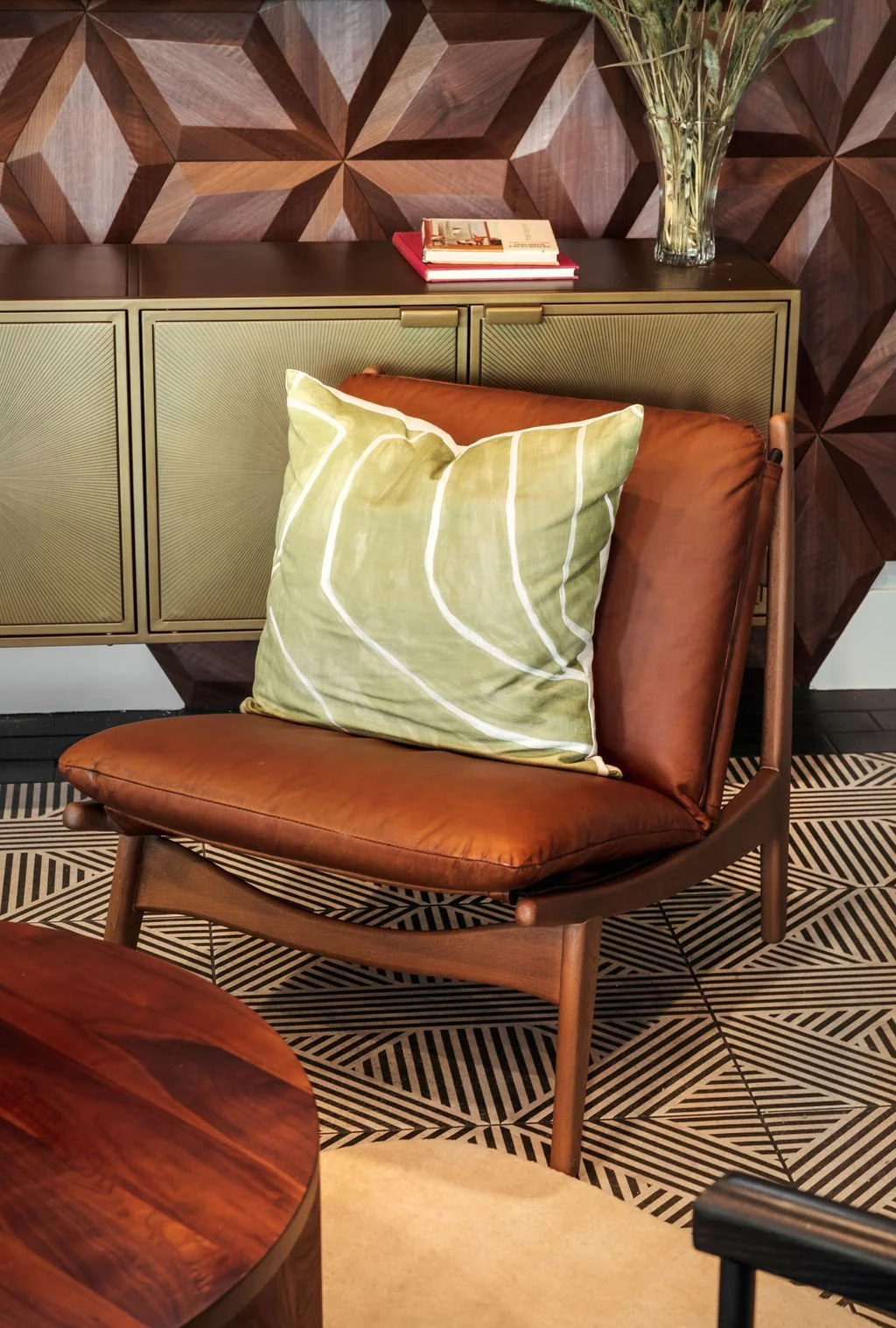The Franklin Peoria AZ multifamily clubhouse - custom wood tile feature wall geometric print flooring leather chair