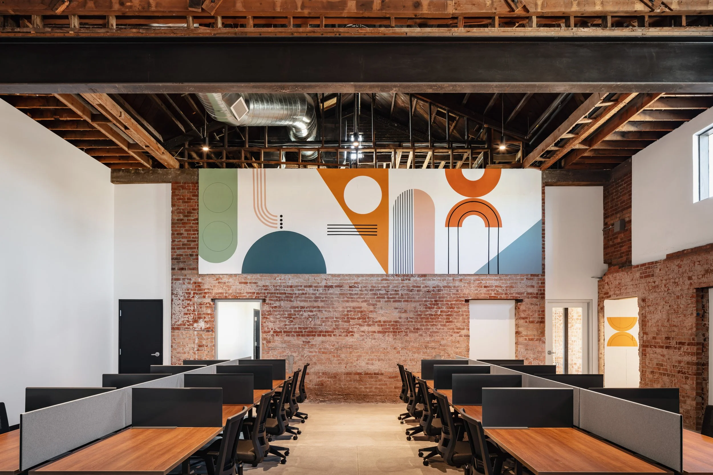 Lemonade Insurance Scottsdale office design - open bullpen workstations with local artist mural adaptive reuse