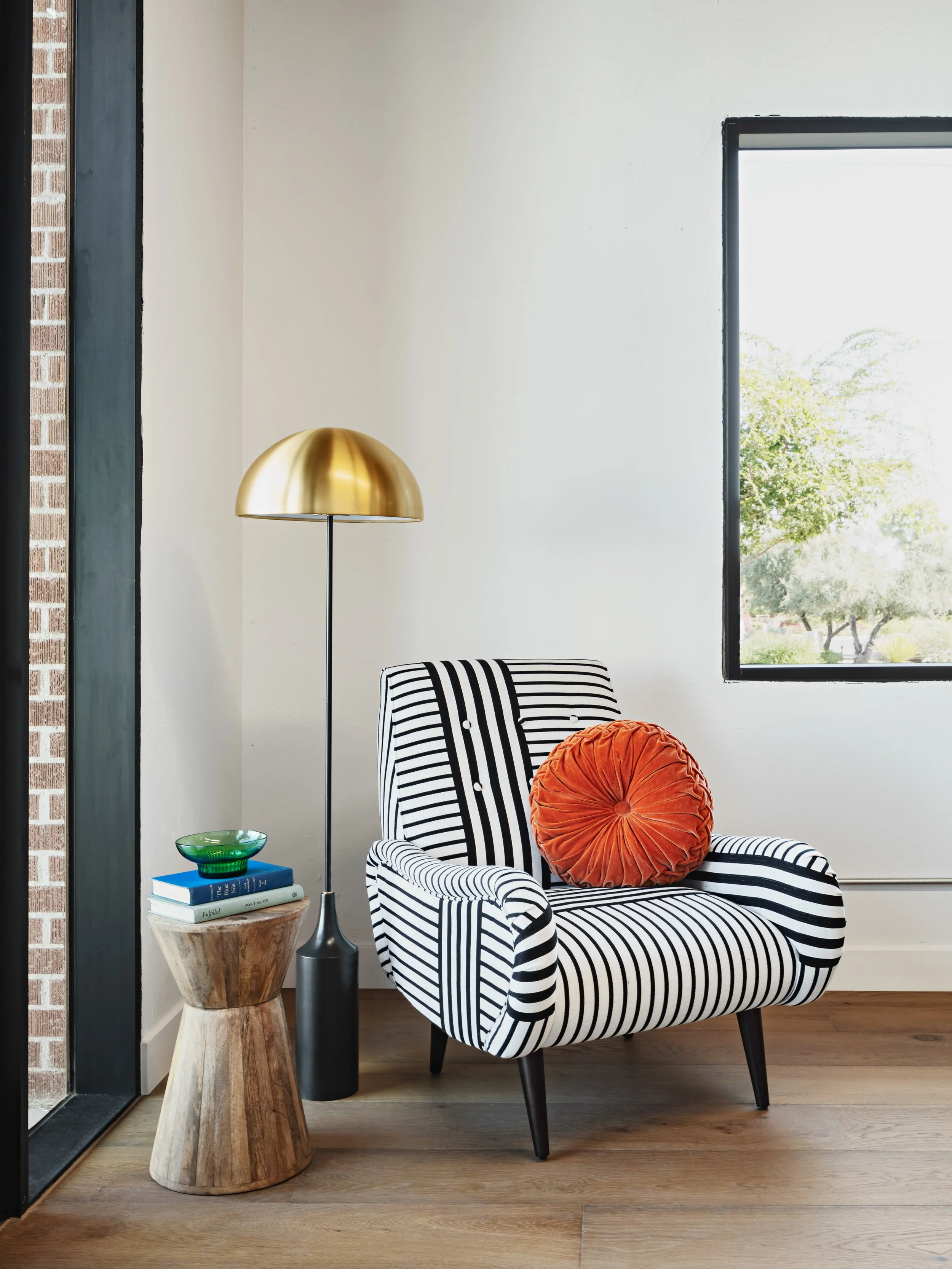 Lemonade Insurance Scottsdale office design - modern lounge chair table and lamp lobby with original metal frame windows adaptive reuse