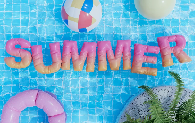 A pool with gradient pink and orange floaties that spell "summer." There are pool toys in the pool as well.