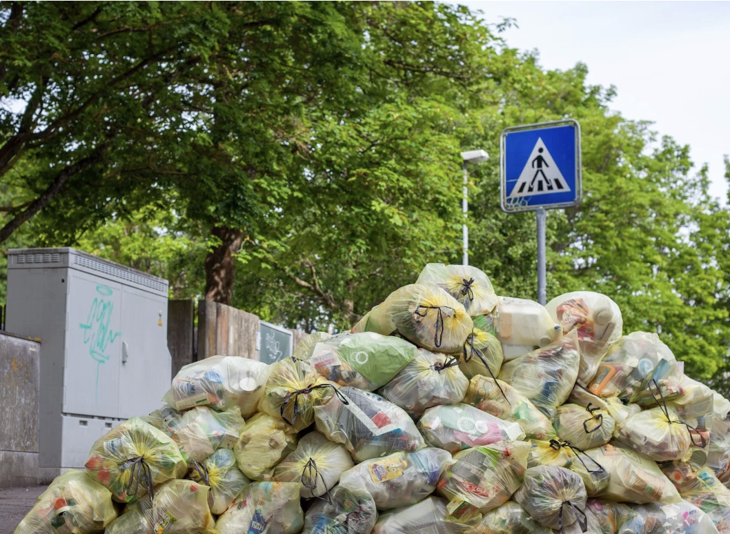 A large pile of full trash bags.