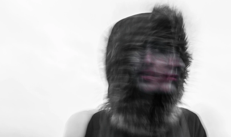 an overexposed image of a woman's face shaking