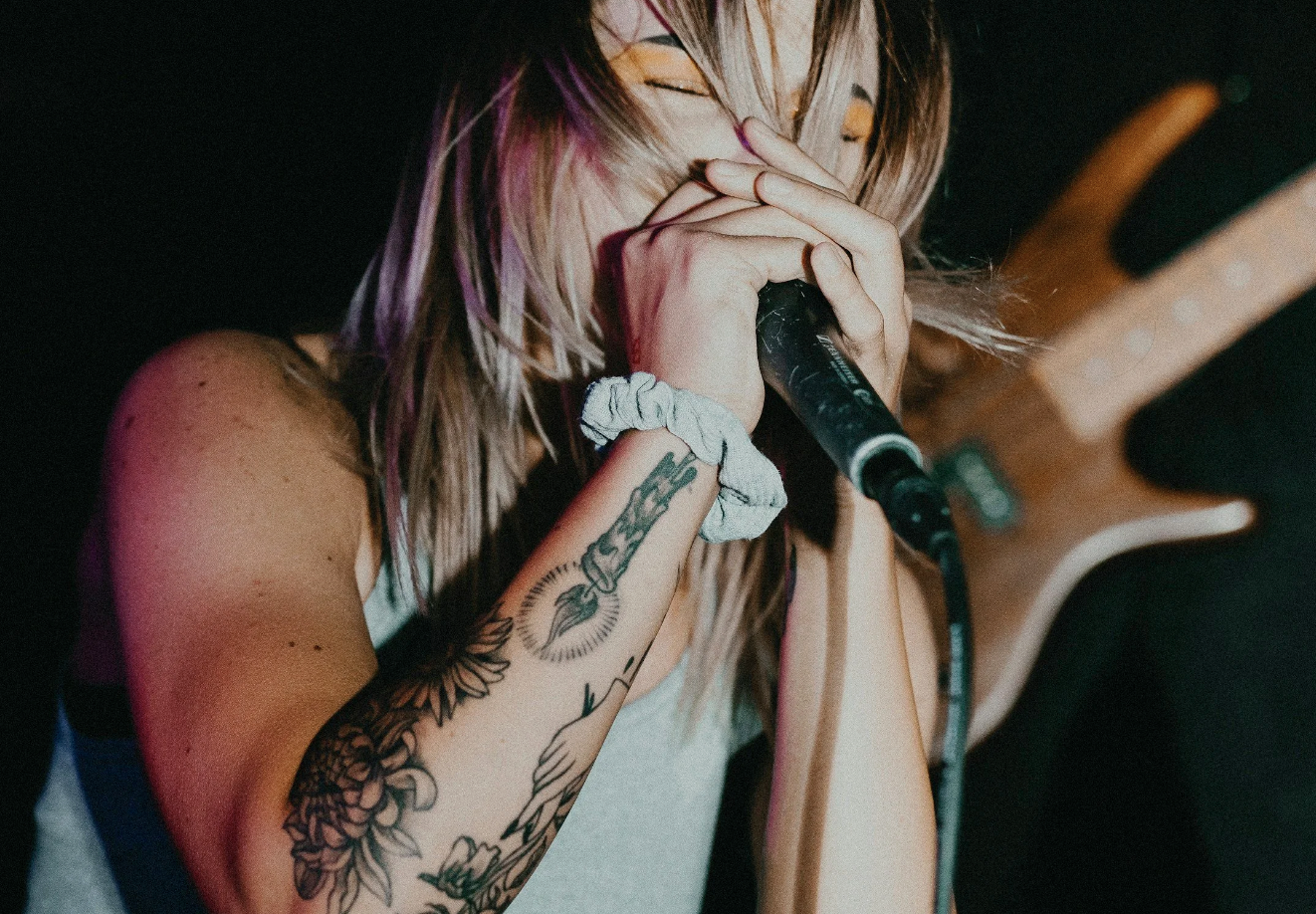 Person singing into a microphone