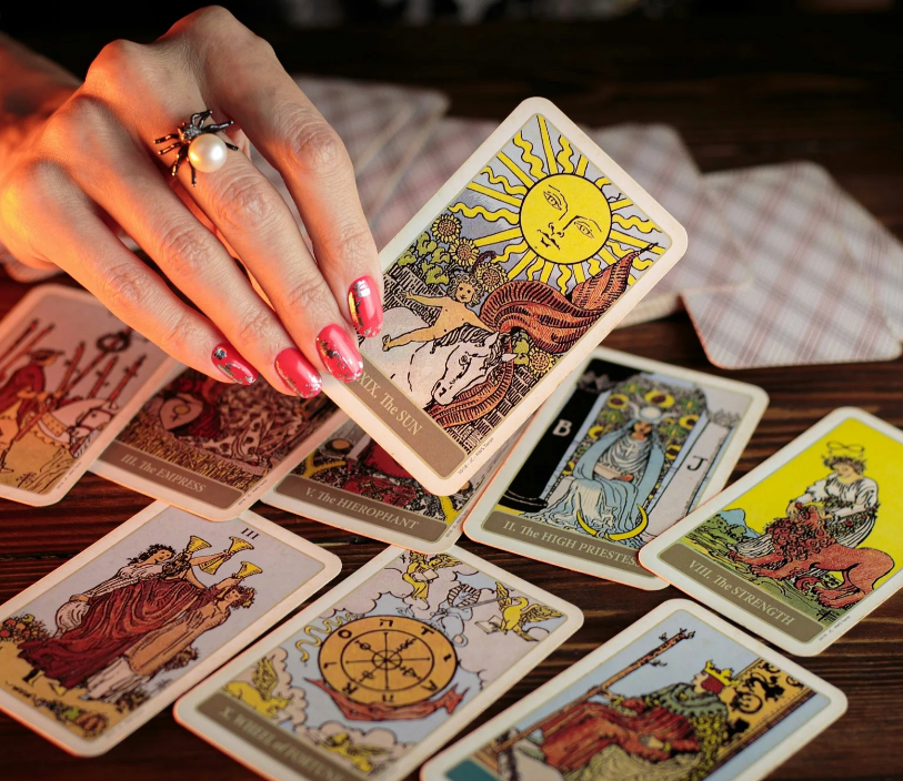 a woman holding a tarot card