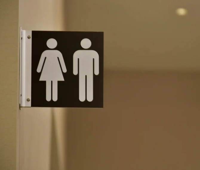 A sign with male and female bathroom figures